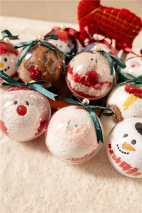 Detailed view of Christmas coral fleece socks in decorative holiday bauble gift packaging