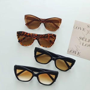 Retro cat-eye oversized sunglasses in assorted colors on a neutral background