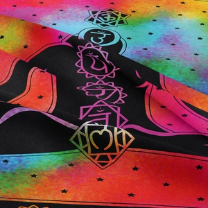 Detail of bohemian chakra tapestry featuring rainbow gradients and star patterns on fabric