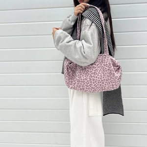 Detailed side view of large pink leopard print tote bag with soft pleated suede texture