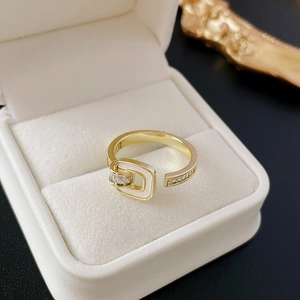 Macro shot of gold square zircon open ring with detailed pave crystals on white box