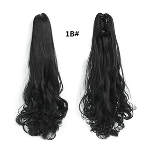 Detail view of 1B black wavy ponytail extension showing the claw clip and texture