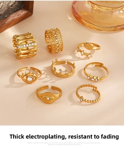 Detailed close-up of 8-piece gold plated ring set with evil eye and rhinestone accents