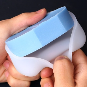 Close-up showing flexible silicone mold for easy removal of a rectangular candle