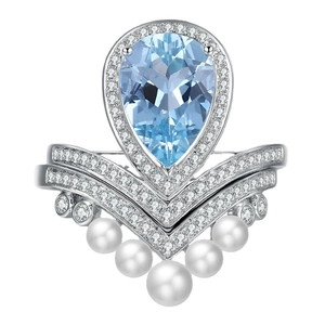 Elegant pear-shaped blue gemstone ring with crown diamonds and hanging white pearls