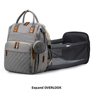 Detail view of the gray diaper bag unfolding into a portable crib with breathable mesh