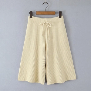Detail of cream knit wide-leg shorts with vertical texture and drawstring elastic waist