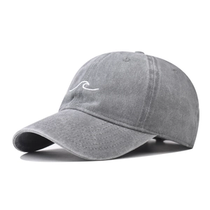 Detailed view of white wave embroidery on charcoal grey washed vintage baseball cap fabric