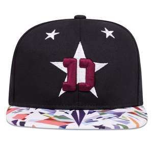Black snapback hat featuring 3D embroidered number 11 with colorful geometric pattern brim