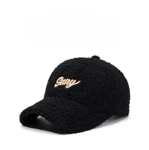 Close-up of black sherpa baseball cap with white Gany embroidery and soft texture