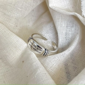 Detail of 925 sterling silver ring with 'Love you to the moon and back' engraving