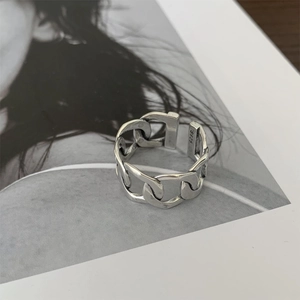 Macro detail of S925 sterling silver chain ring with vintage Thai silver texture and engraving