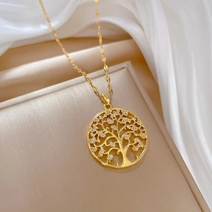 Elegant gold tree of life necklace with crystals on silk background for formal wear