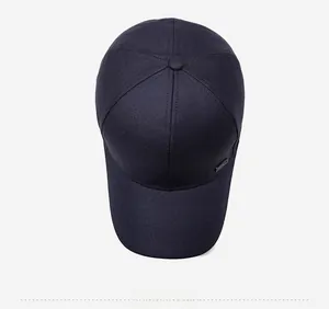 Top view of navy blue cotton baseball cap showing 6-panel structure and metal brand tag