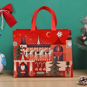 Festive red Christmas gift bag with Santa and nutcracker illustrations on a green background