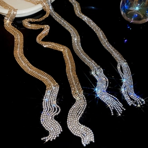 Detailed macro view of sparkling rhinestone fringe chains in gold and silver finish
