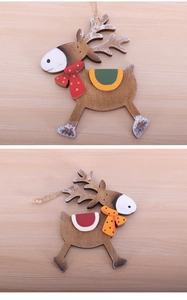 Close-up of colorful wooden reindeer ornaments with jute twine and snow-dusted edges