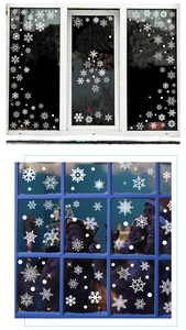 Close-up of white snowflake window clings showing various shapes for Christmas decor