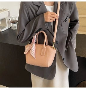 Detailed close-up of pink lychee pattern bucket bag with silk scarf on the handle