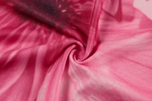 Macro shot of soft pink and purple tie-dye printed knit fabric with fine texture detail