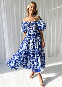 Detailed close-up of blue and white floral off-shoulder maxi dress with tiered ruffle skirt