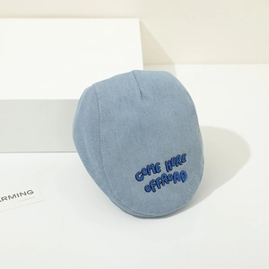 Detail of light blue denim baby cap with COME HERE OFFROAD blue embroidery text