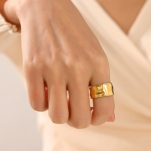 Irregular textured gold wide open ring with hammered finish on model finger