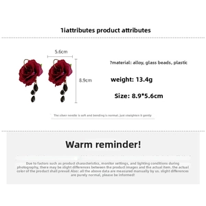 Macro detail of red rose tassel earrings with dimensions and material specs shown