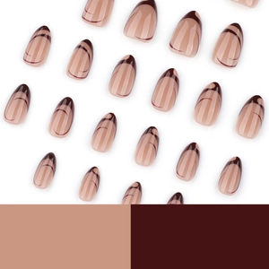 French style press-on almond nails with brown swirl patterns on a nude base