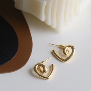 Elegant polished gold heart-shaped stud earrings with a stylish twisted C-shape design