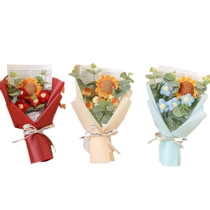 Hand-knitted sunflower and daisy crochet bouquets with red, beige, and blue wrapping