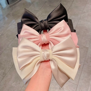 Luxurious satin oversized layered bow hair clip set in black, pink, and champagne white