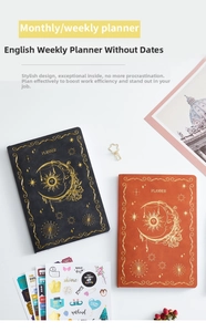Close-up of faux leather planner covers with gold sun and moon constellation patterns
