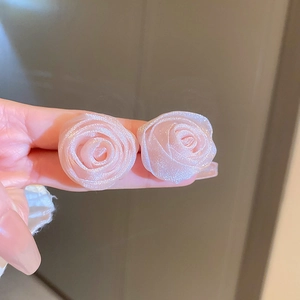 Macro detail of pink flower earrings with pearlescent finish and translucent petals