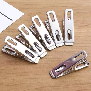 Set of 7 durable stainless steel laundry clips on wooden background for windproof drying