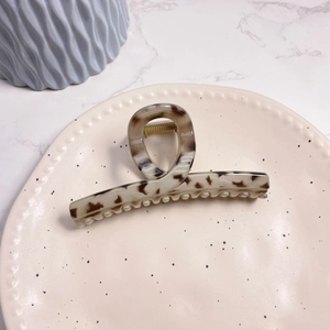 Tortoise shell acetate shark hair claw clip with minimalist curved design and gold spring