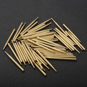 Pile of precision machined solid brass pins and locating needles for hardware assembly