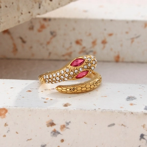 Macro detail of gold snake ring with pink marquise eyes and pave crystal setting