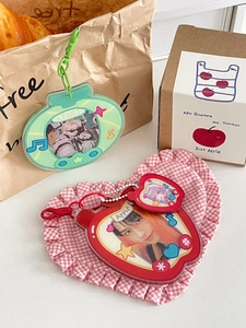 Detail of cute acrylic photo card holders in retro game console and red apple designs
