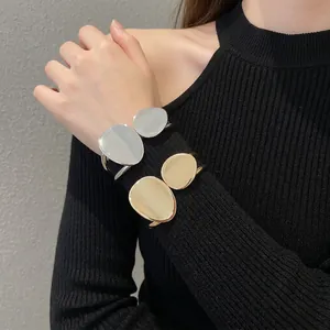 Minimalist irregular double oval metal open bangle bracelet in polished gold and silver
