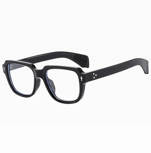 Close-up of black square thick frame sunglasses with silver rivet detail and clear lenses