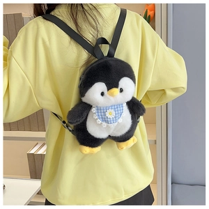 Cute plush penguin backpack featuring blue checkered bib with daisy pattern on model back