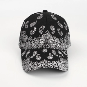 Detail of vintage black paisley baseball cap with intricate white ethnic patterns