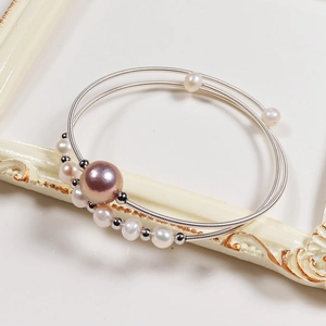 Macro shot of multi-layer wire-wrapped bracelet with purple and white freshwater pearls