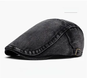 Detail of black washed denim flat cap showing texture and copper metal adjustment buckle