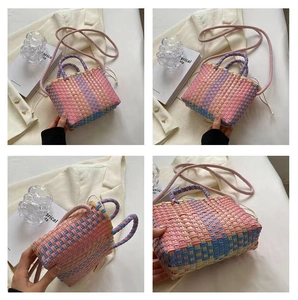 Close-up of pink, blue, and beige checkered weave patterns on a stylish bucket bag