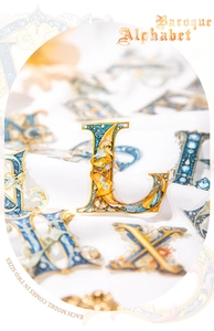 Macro view of Baroque style gold and blue PET letter sticker L in two different sizes