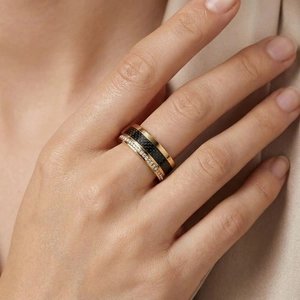 Detail of gold titanium ring with black carbon fiber inlay and double row diamonds on hand