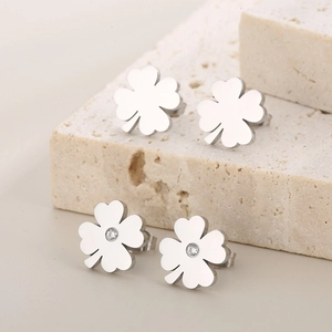 Elegant four-leaf clover stud earrings with polished metal and sparkling zircon stones