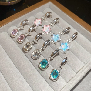 Close-up of sparkling star resin charms and colorful crystals in a jewelry box